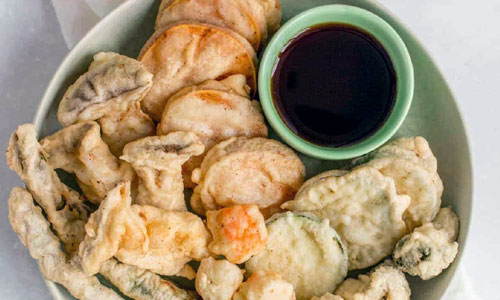 A serving basket of crispy Vegetable Tempura
